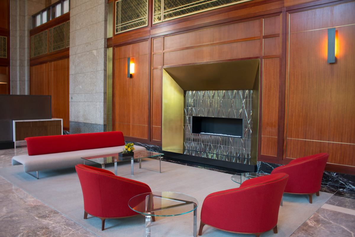Atrium fireplace with acoustical brass panels and casework