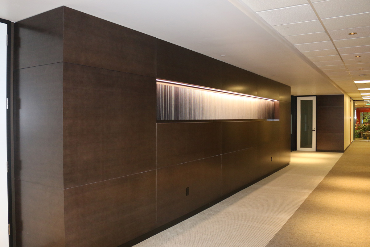 Hallway with wood paneling and art niche